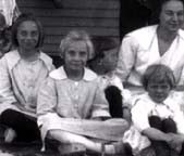 Pauline, Roberta, and Jeanette Bras ( Helen Dondanville and Elizabeth Dondanville Howser in background) ,Lonepine, Montana , 1921.